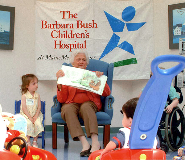 Barbara Bush reading to a group of young children at the BBCH